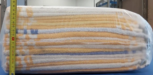 Stack towels compressed by machine